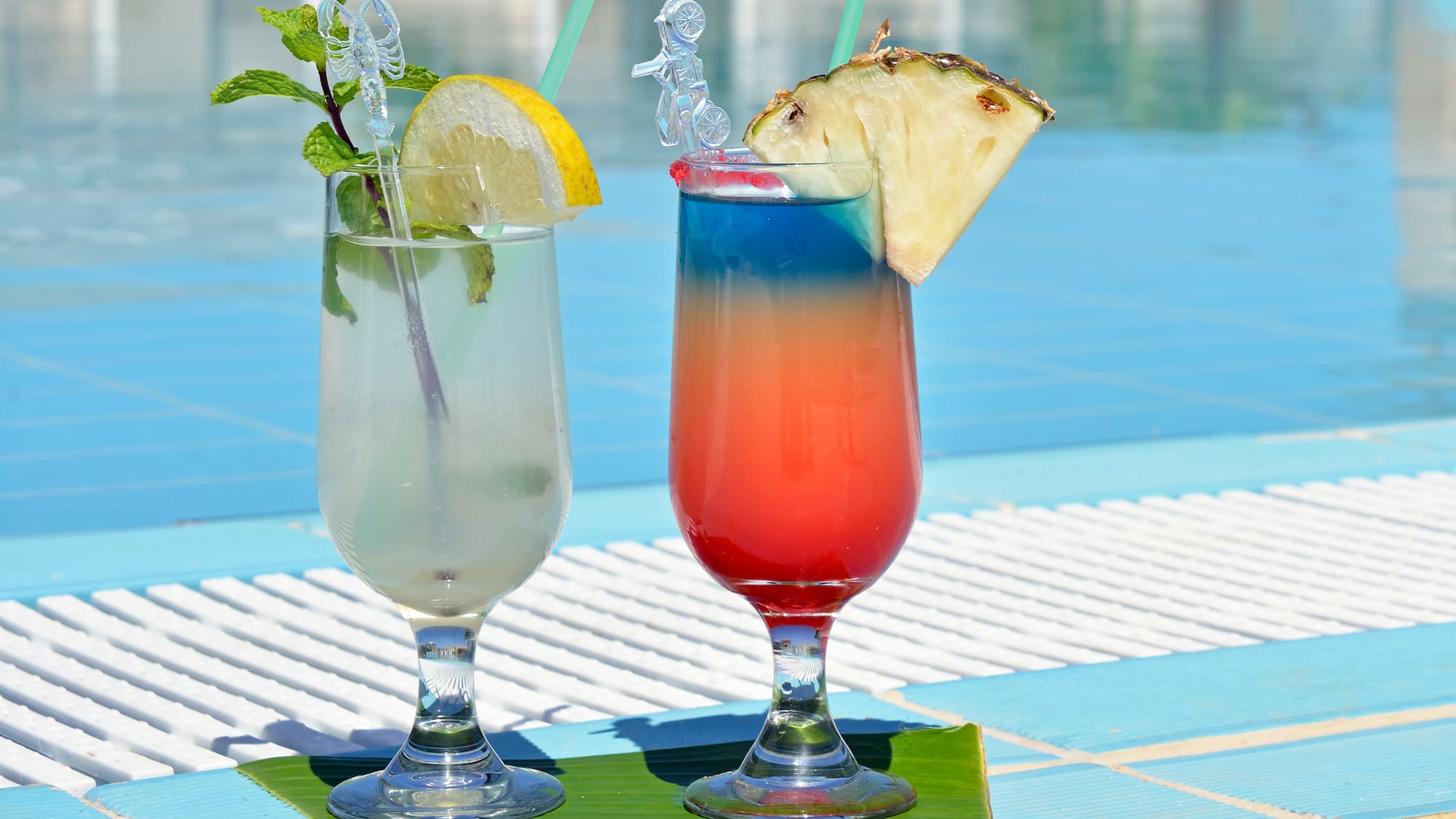 two glasses with drinks on a table