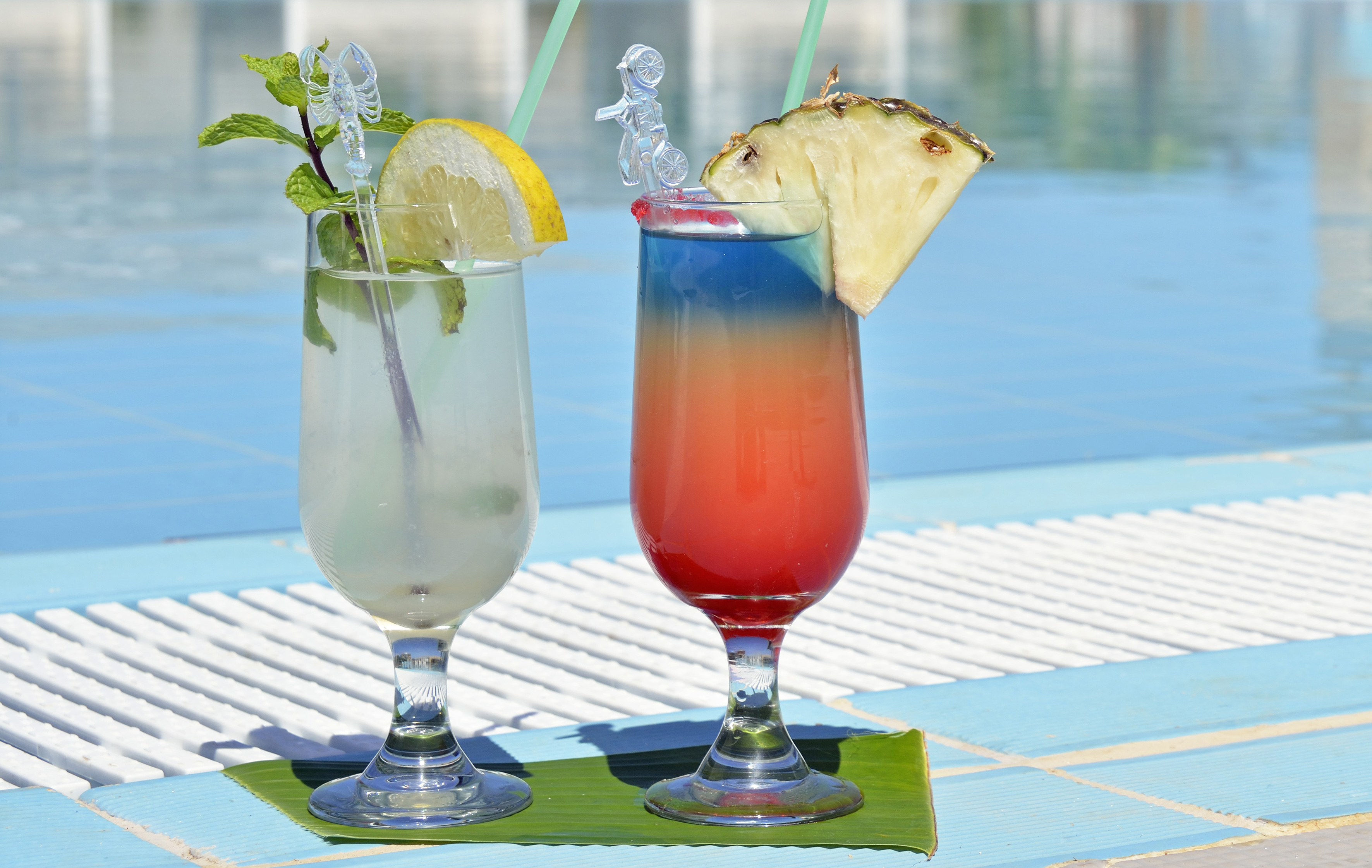 two glasses with drinks on a table