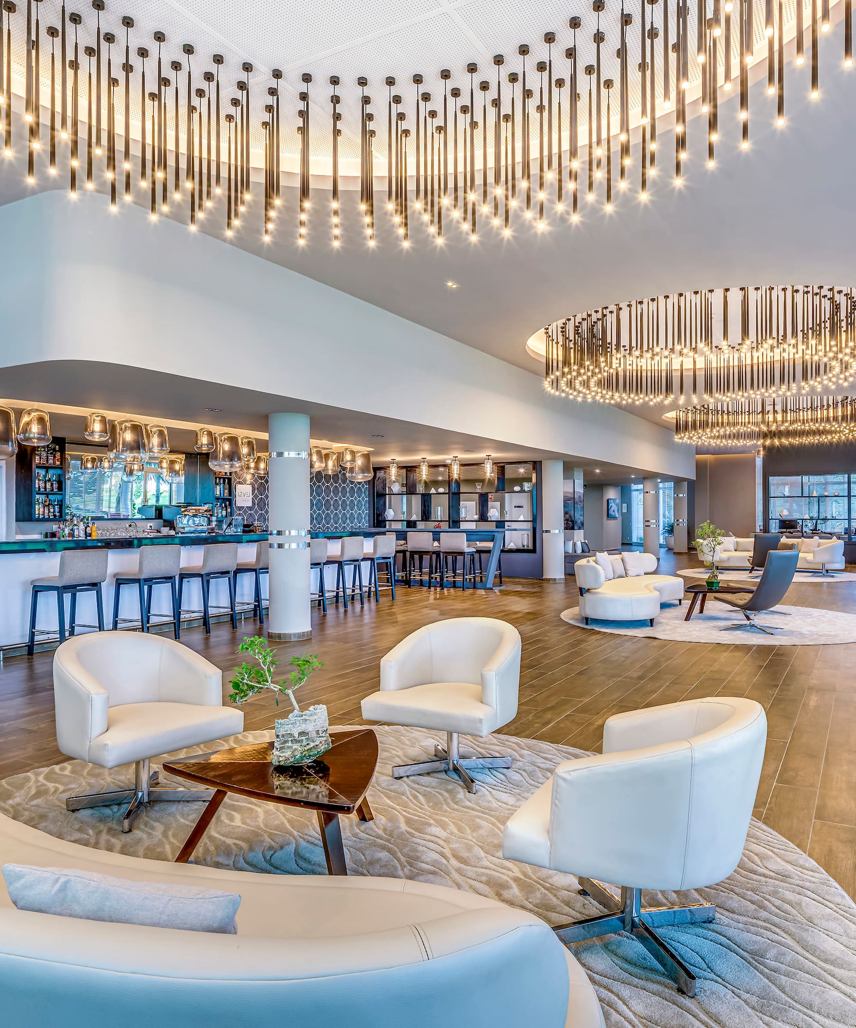 a large room with white chairs and a bar