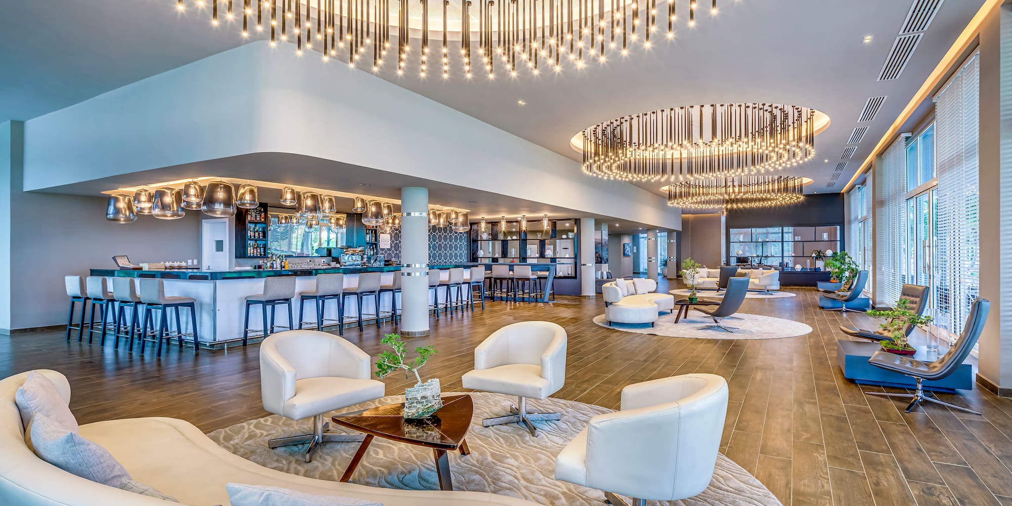 a large room with white chairs and a bar