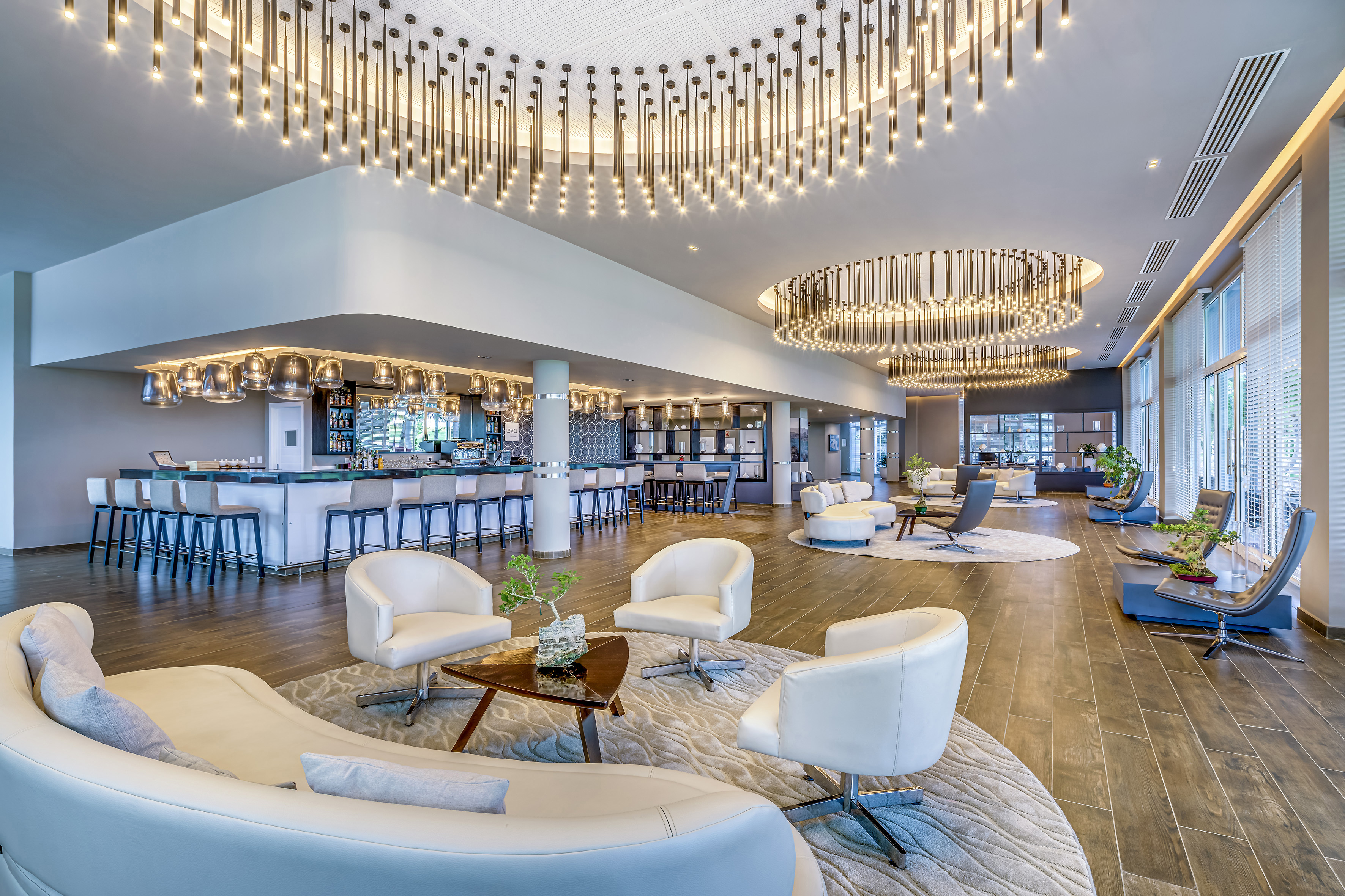 a large room with white chairs and a bar