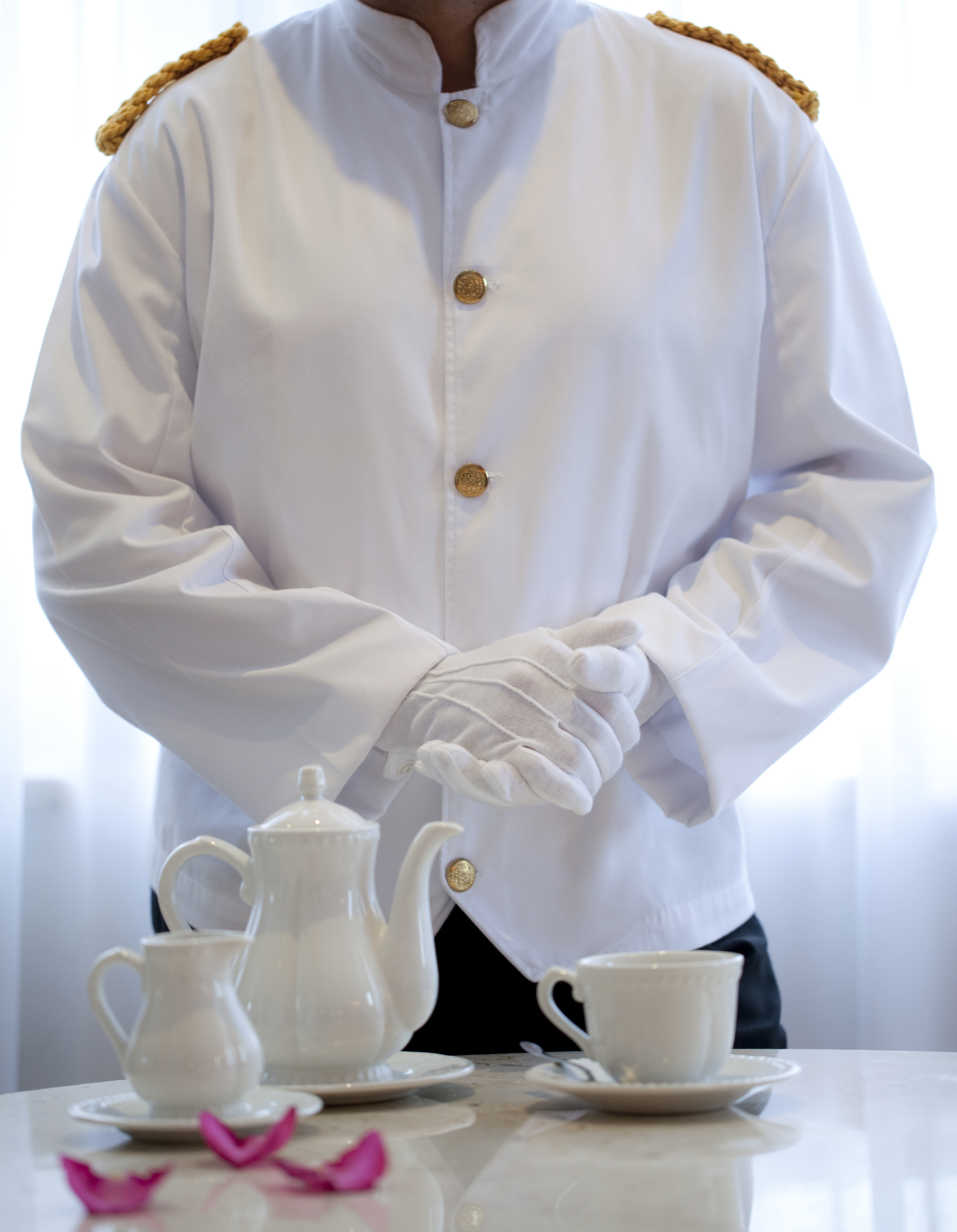 a person in a white coat and gloves