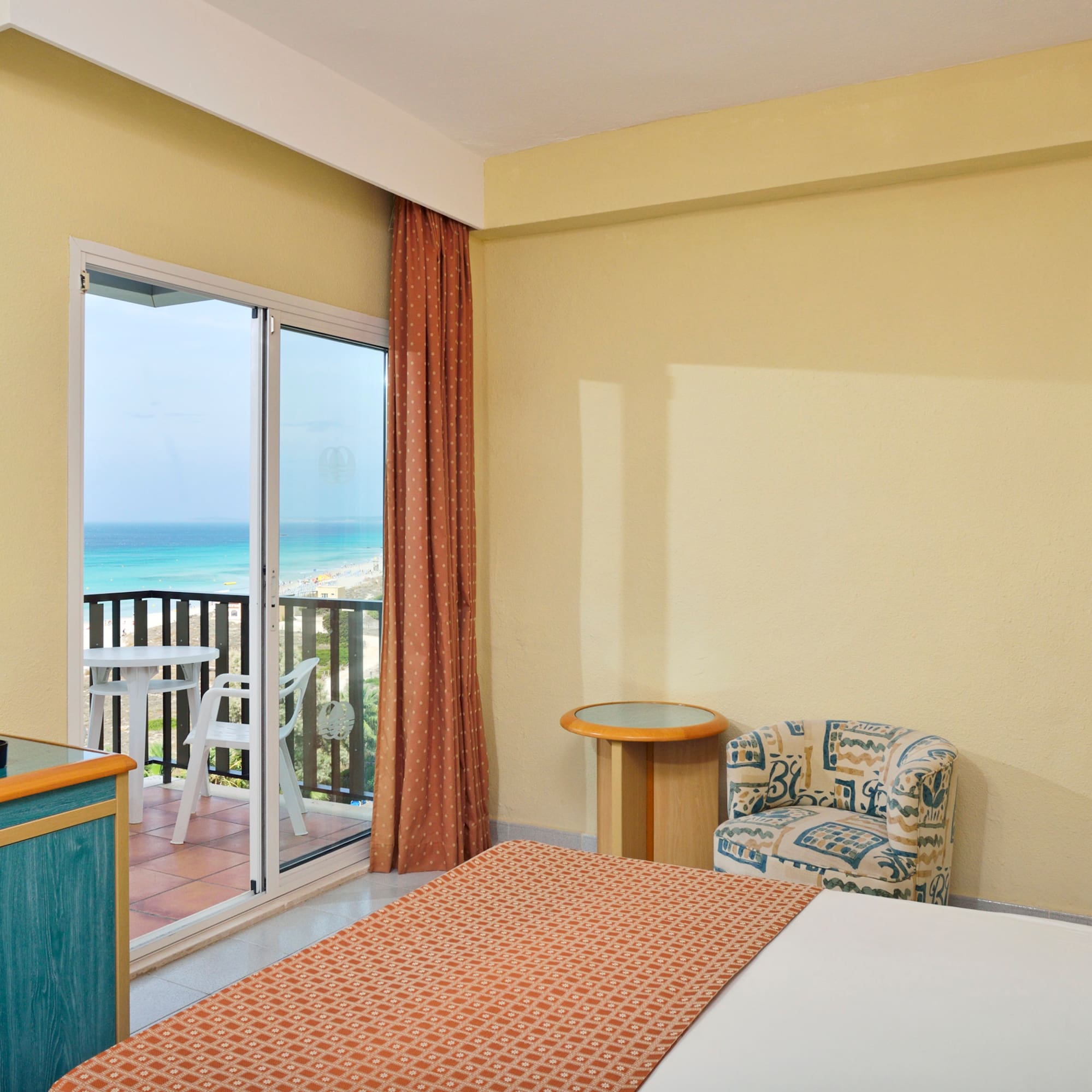 a room with a bed and a glass door