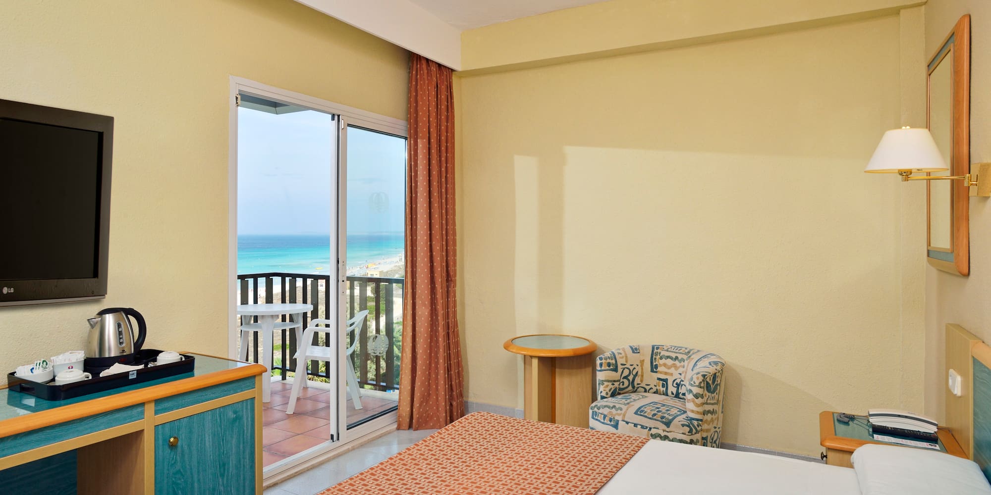 a room with a bed and a glass door