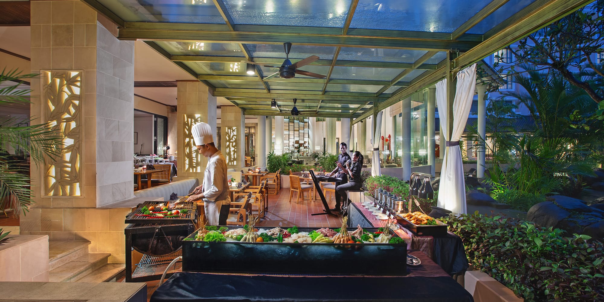 a group of people cooking food in a restaurant