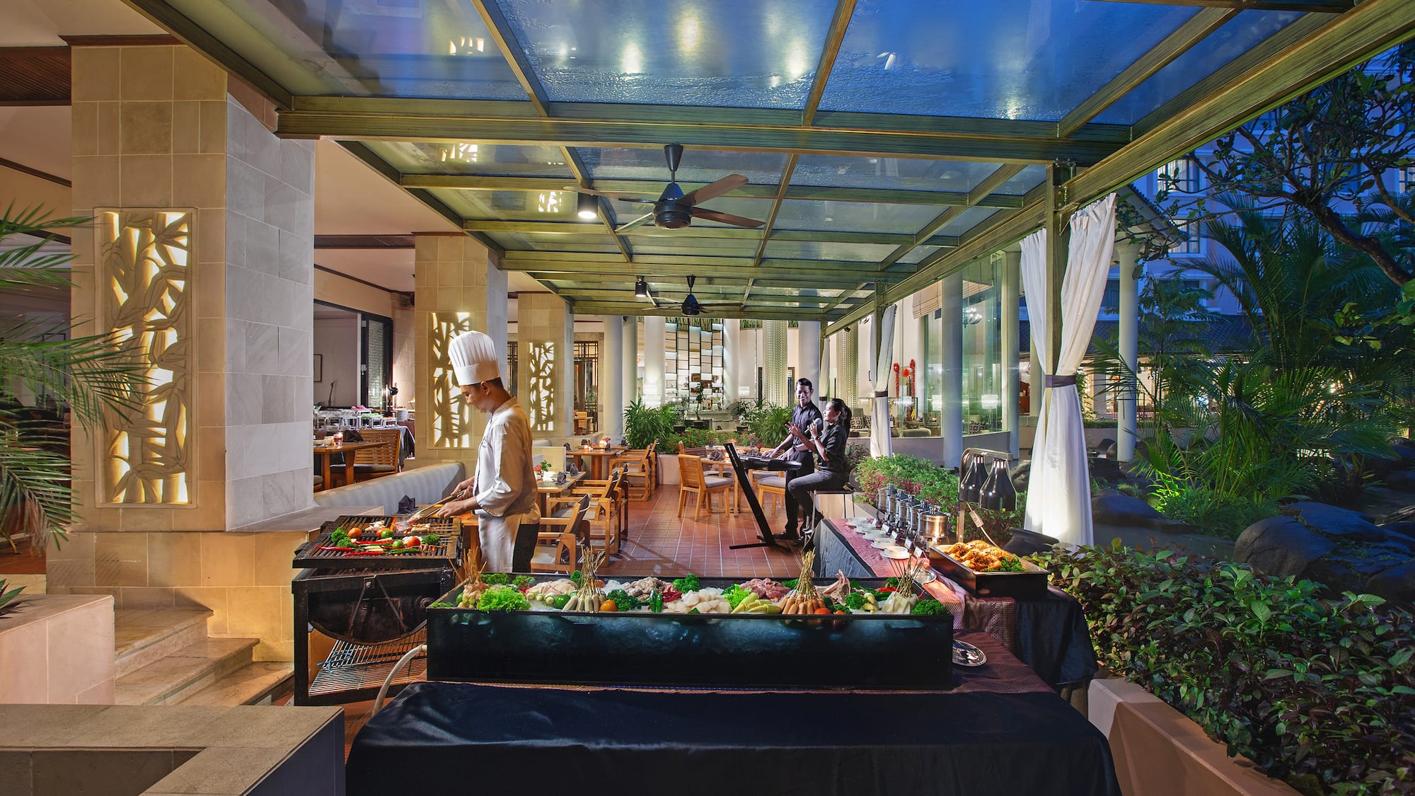 a group of people cooking food in a restaurant