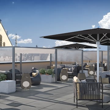 a rooftop patio with chairs and umbrellas