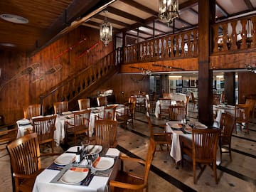 a restaurant with wooden walls and stairs