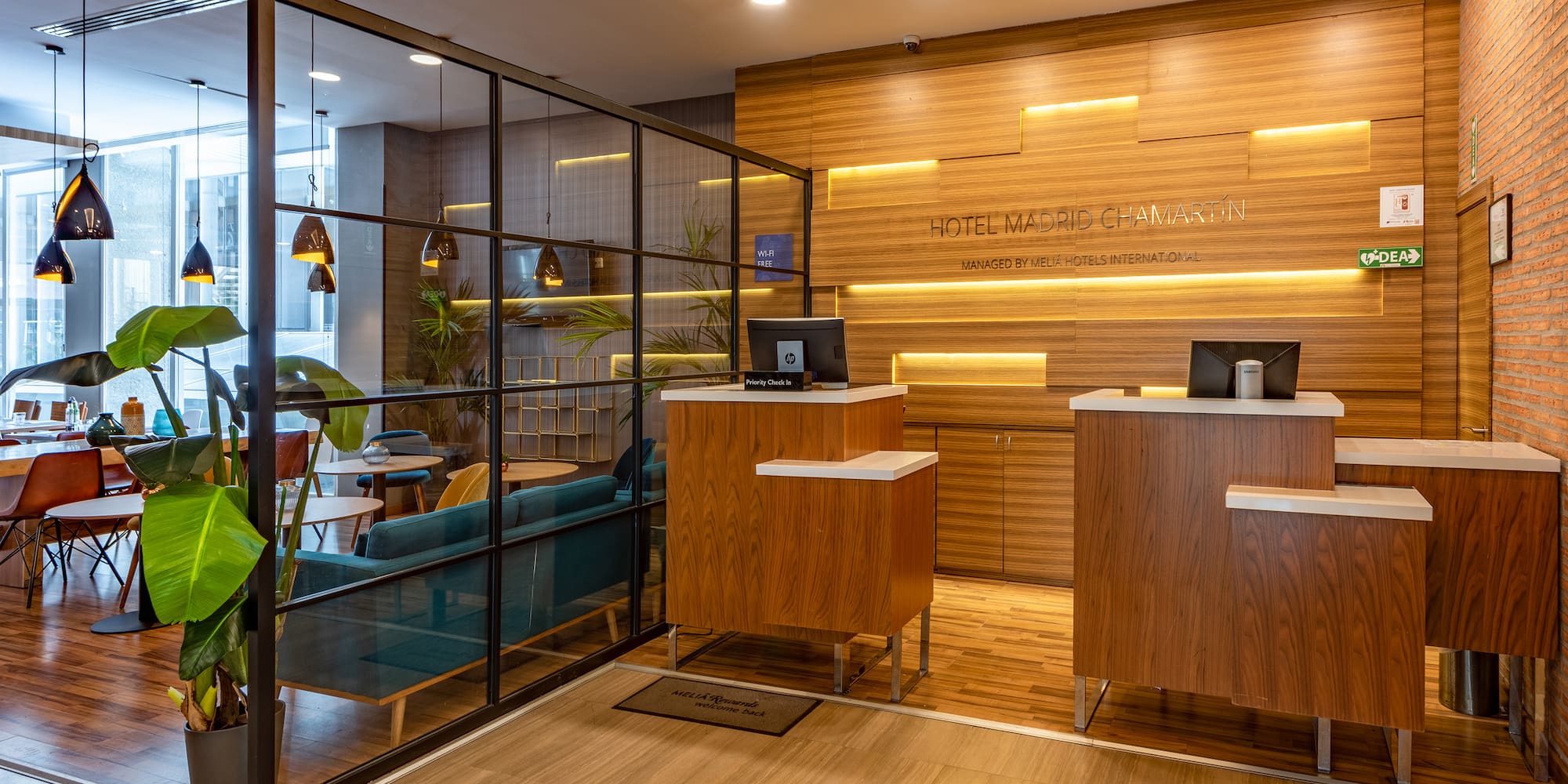 a reception area with a wood floor and glass walls