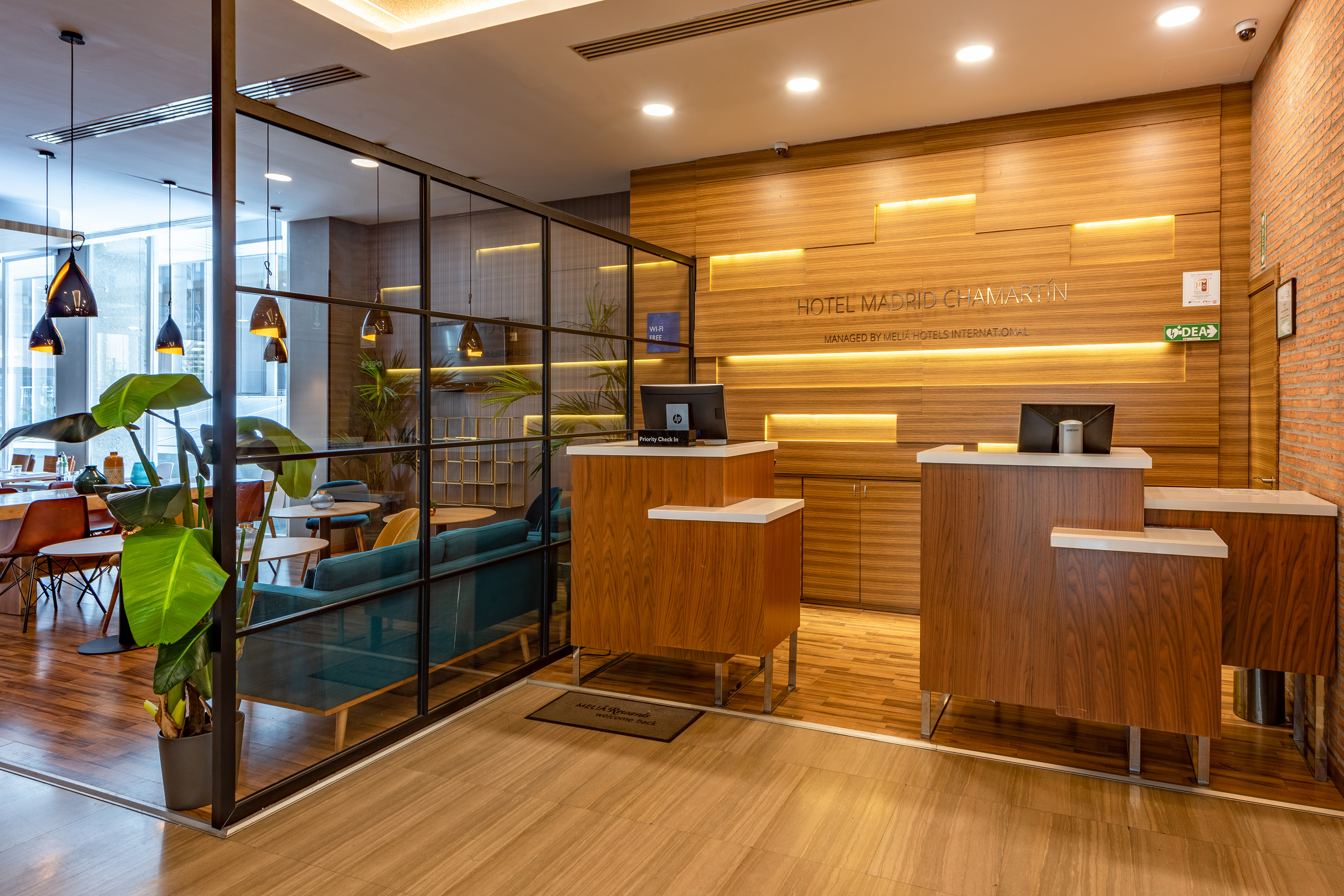 a reception area with a wood floor and glass walls