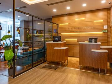 a reception area with a wood floor and glass walls
