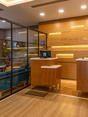 a reception area with a wood floor and glass walls