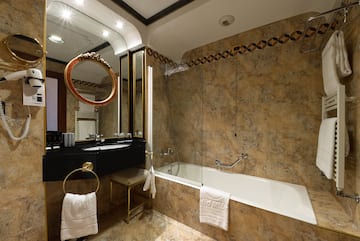 a bathroom with a tub and a mirror