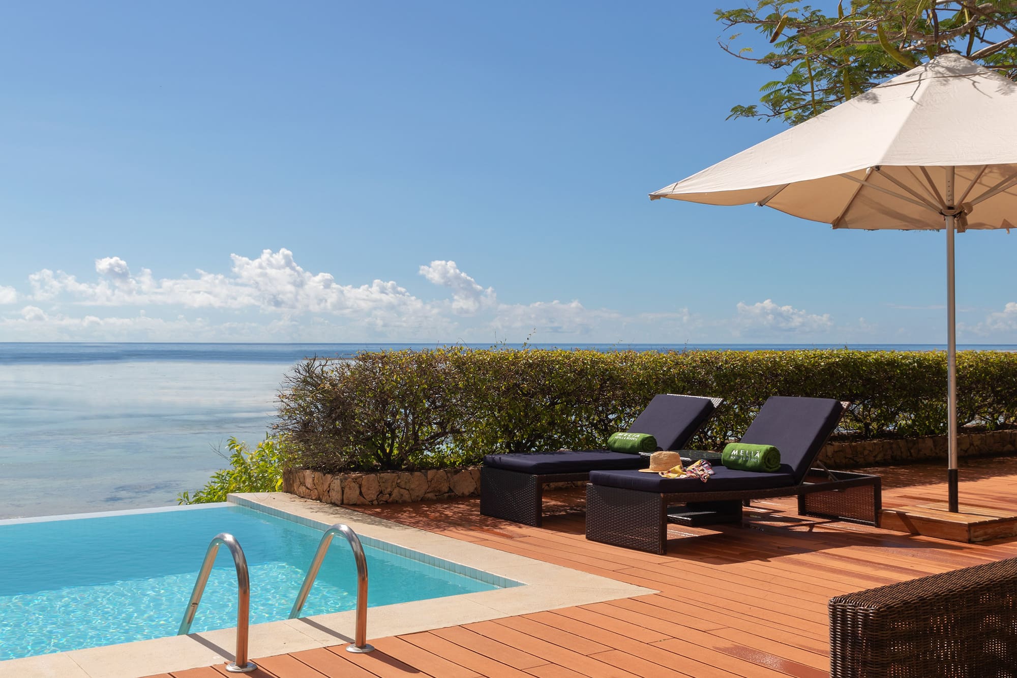 a pool with chairs and umbrella by it