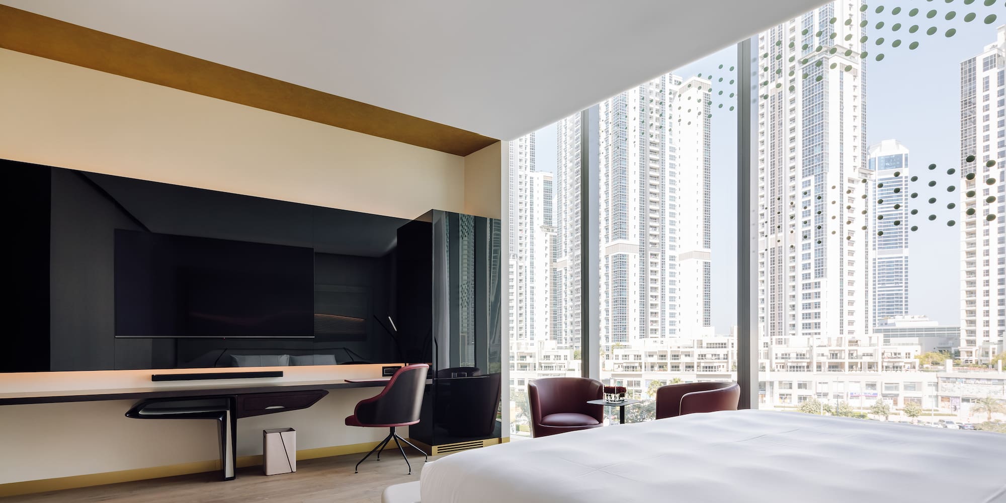 a room with a large bed and a desk and chairs