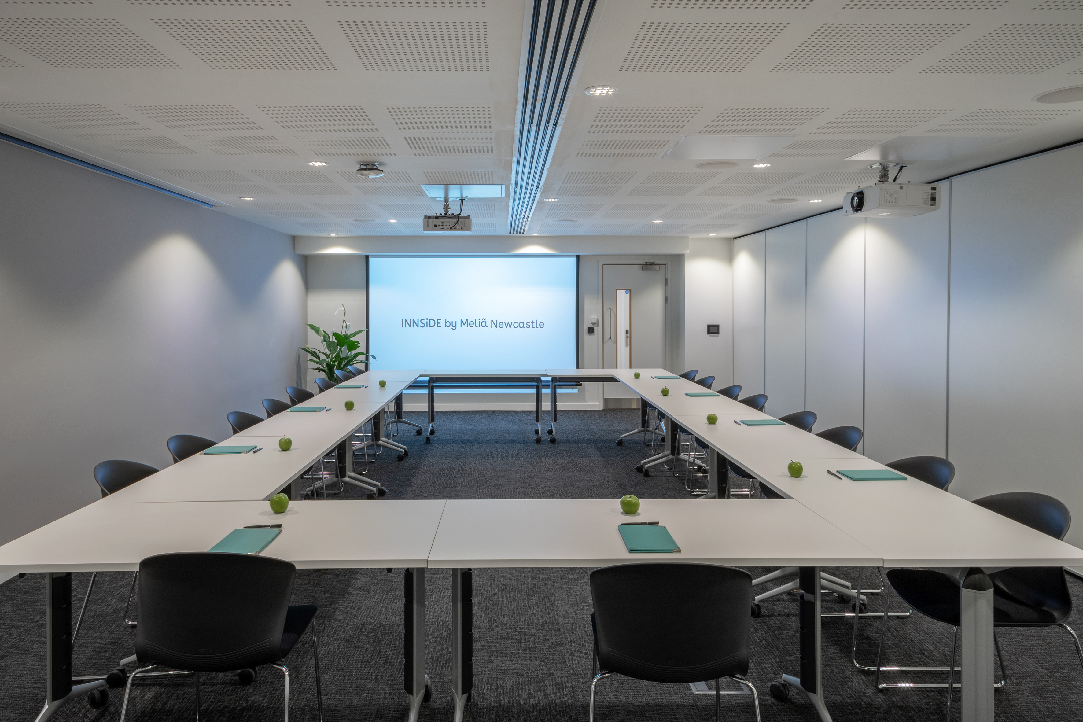 a room with white tables and chairs