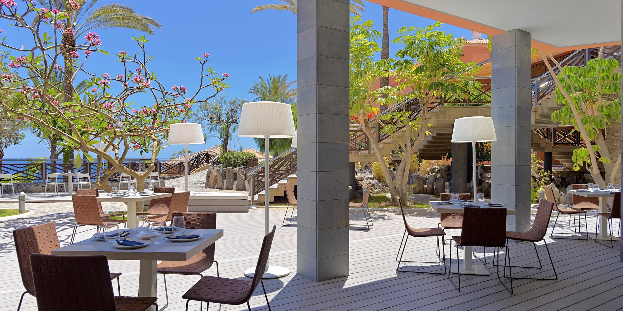 a patio with tables and chairs