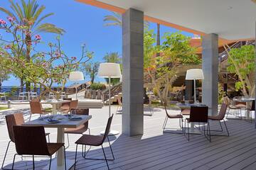 a patio with tables and chairs