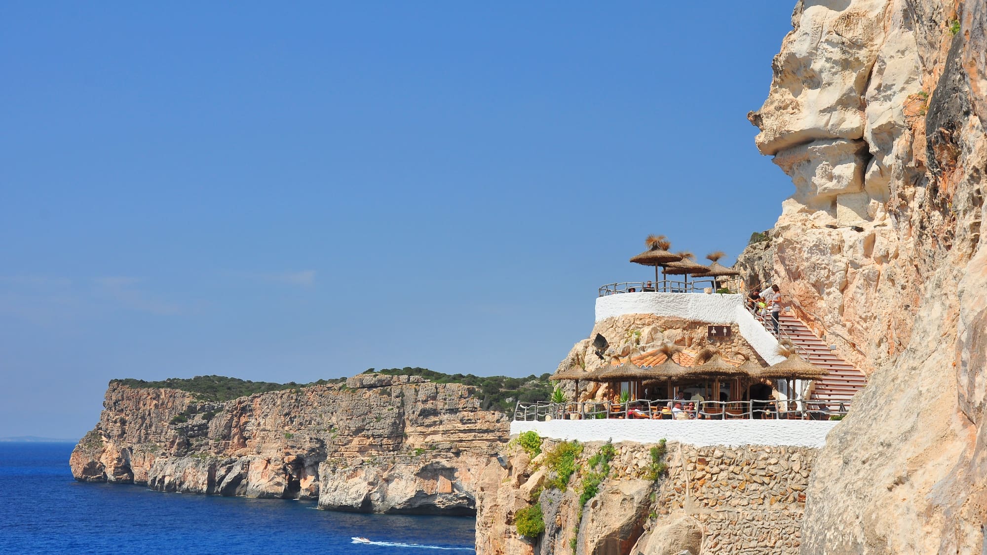 a building on a cliff by the water