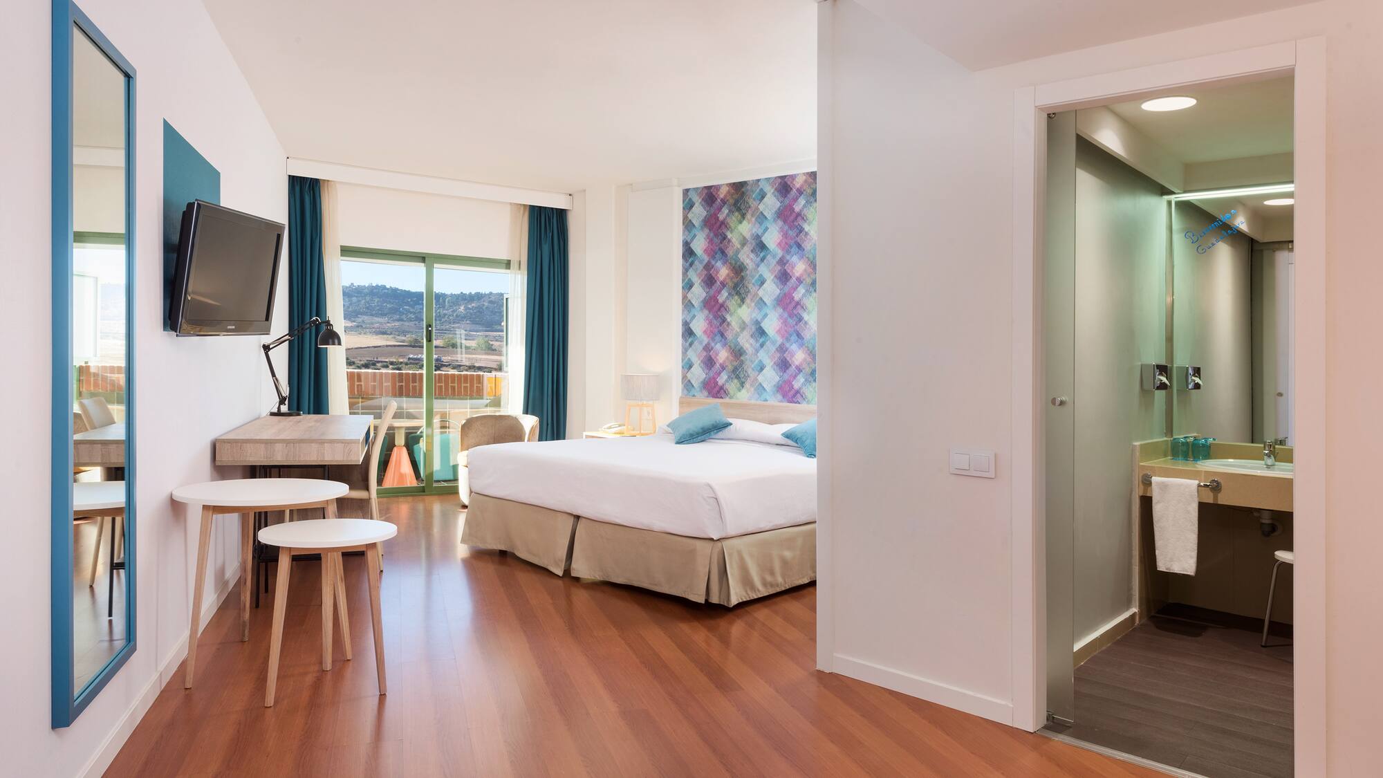 a room with a tv and a bed