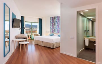 a room with a tv and a bed