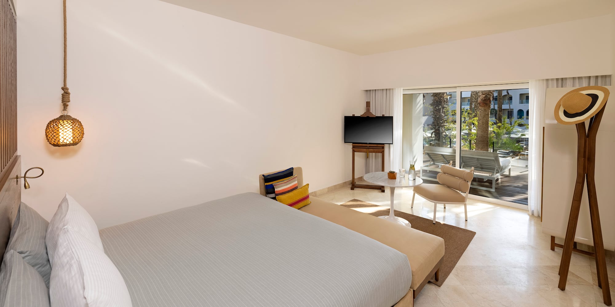 a bedroom with a bed and a television