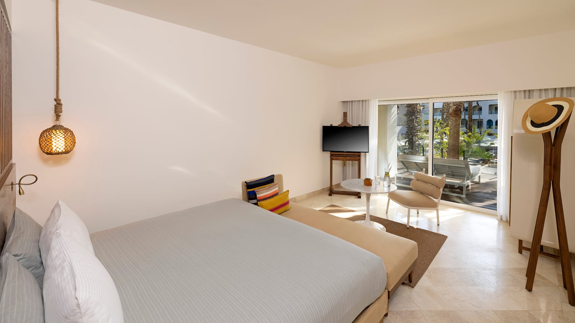 a bedroom with a bed and a television