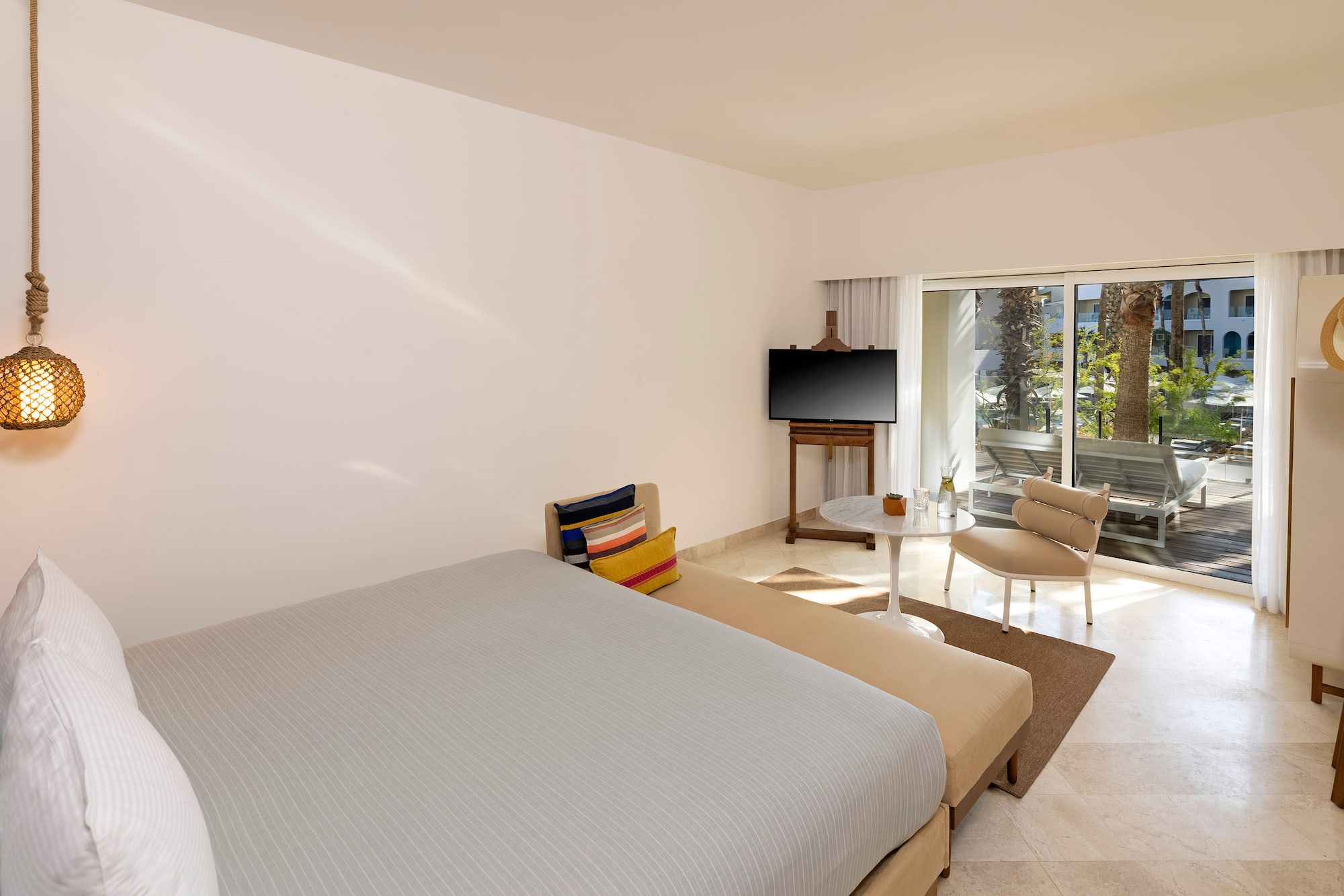 a bedroom with a bed and a television