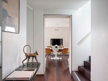 a hallway with a table and chairs