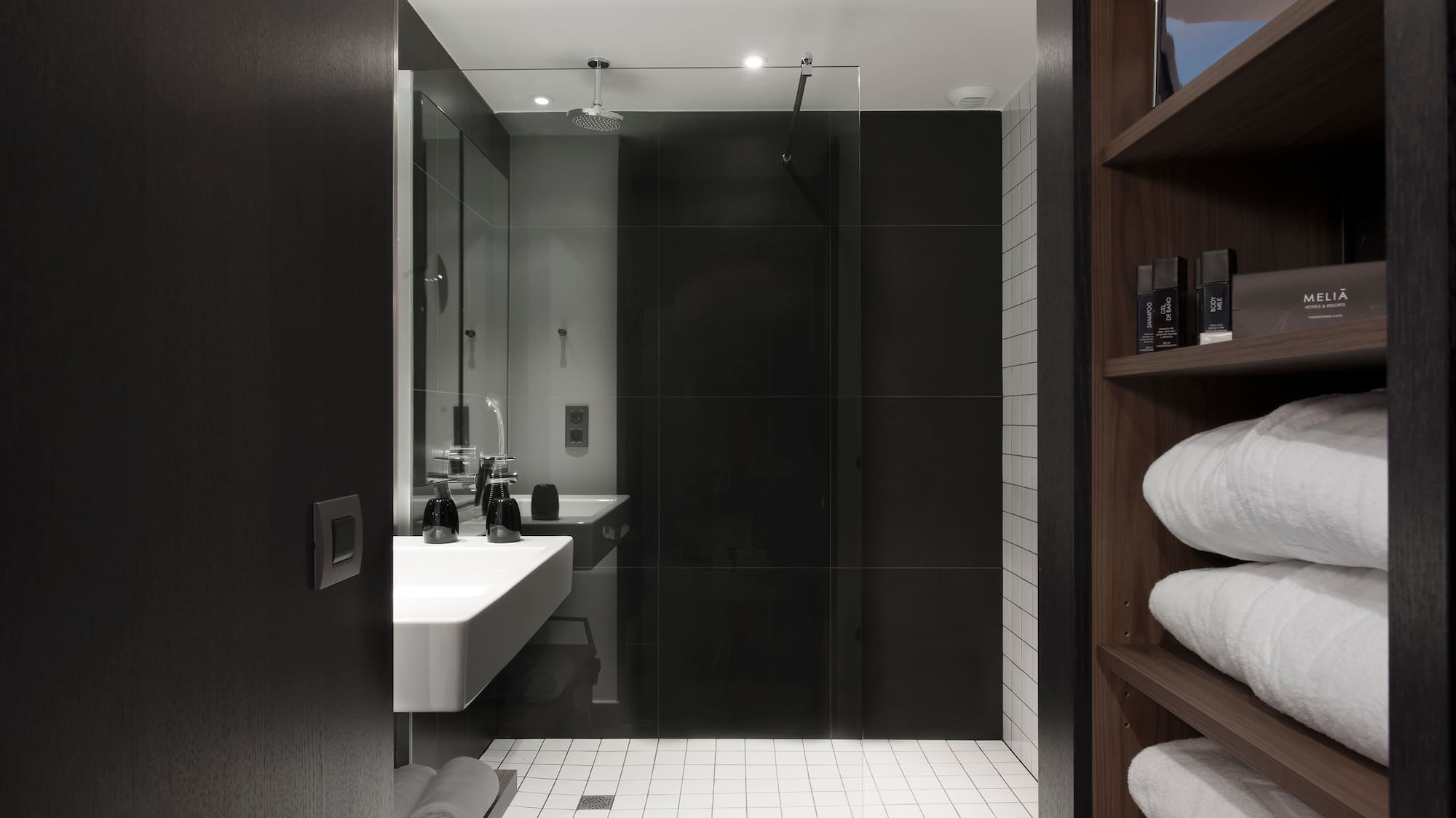 a bathroom with a glass shower door