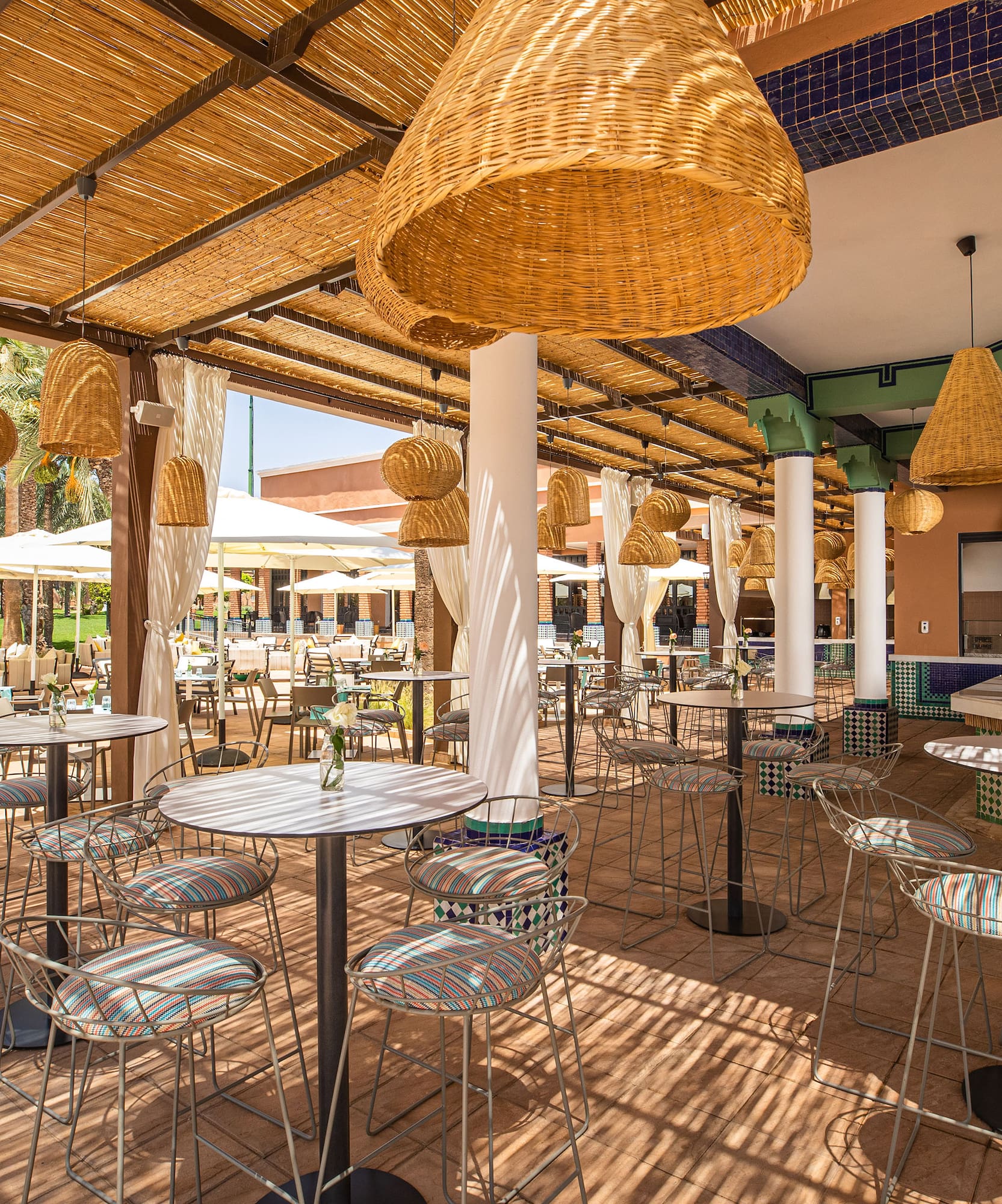 a patio with tables and chairs