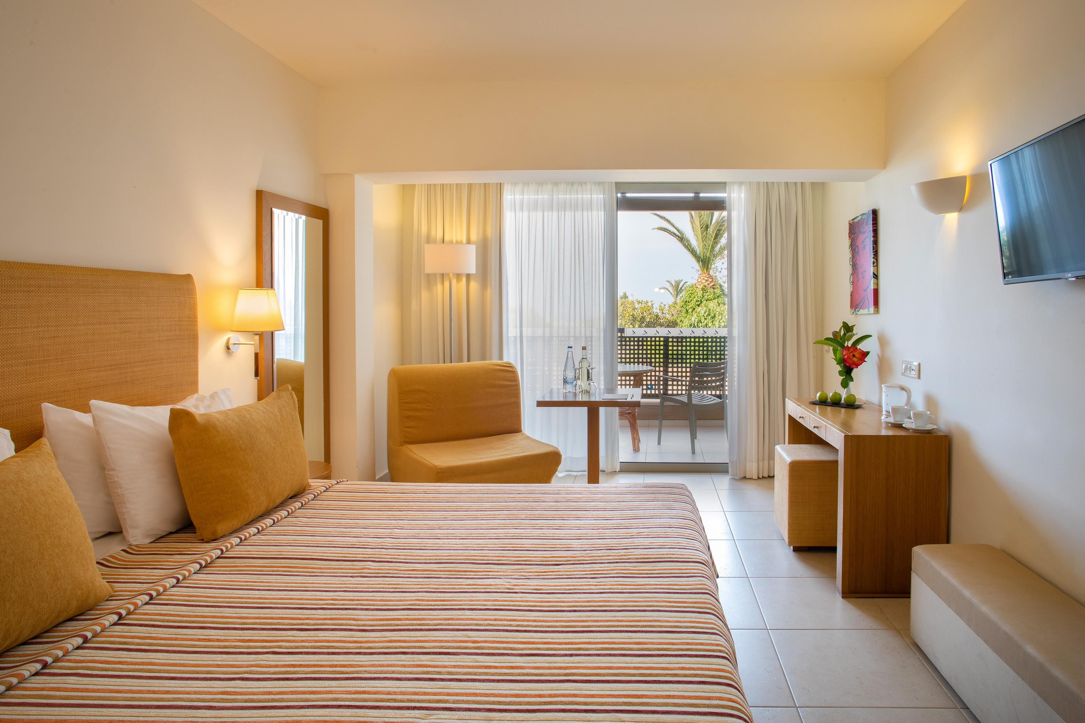 a room with a bed and a table and chairs