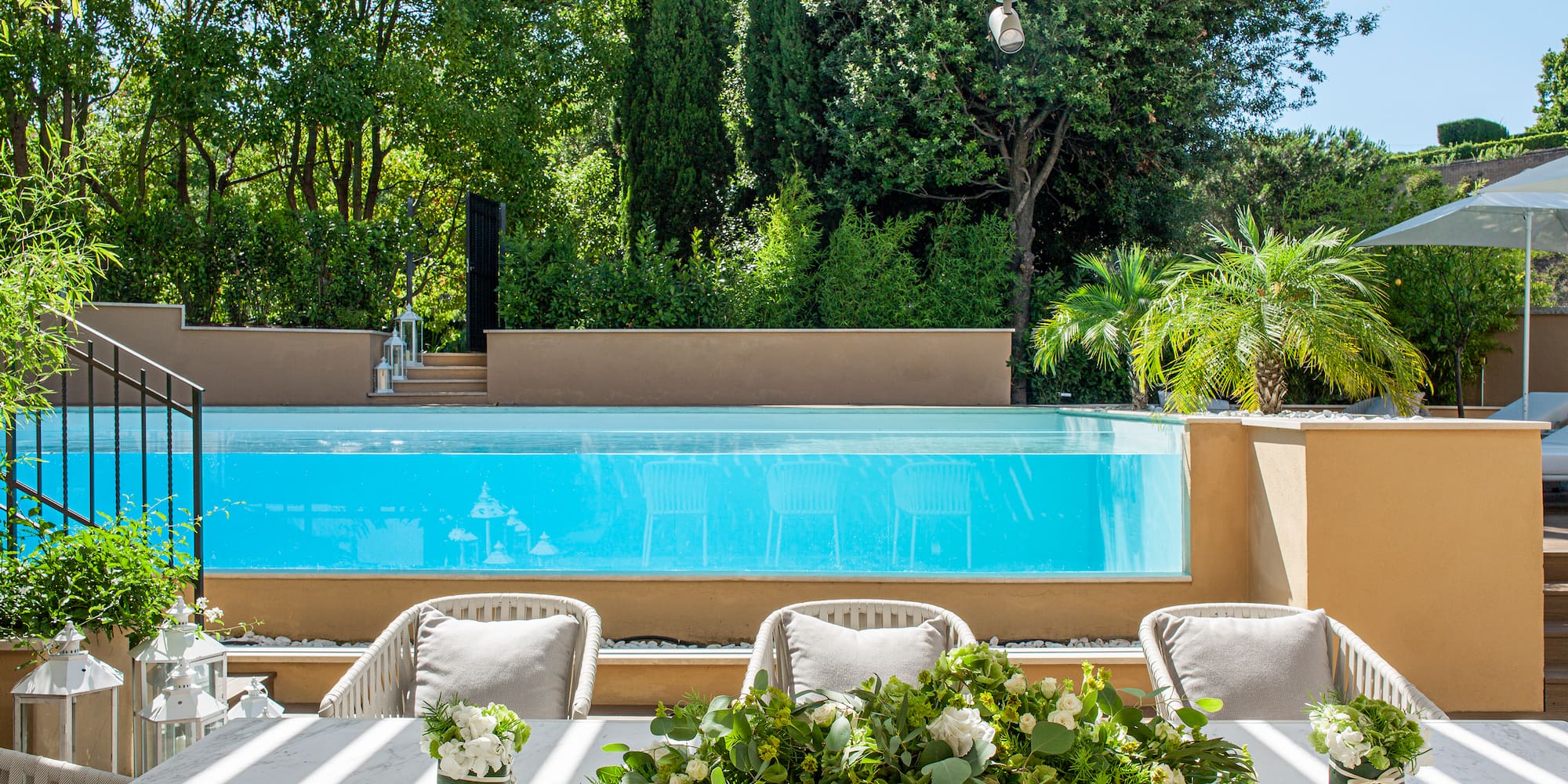 a table with chairs and flowers on it