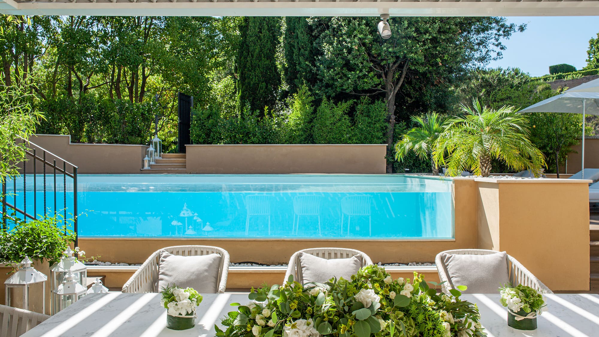 a table with chairs and flowers on it