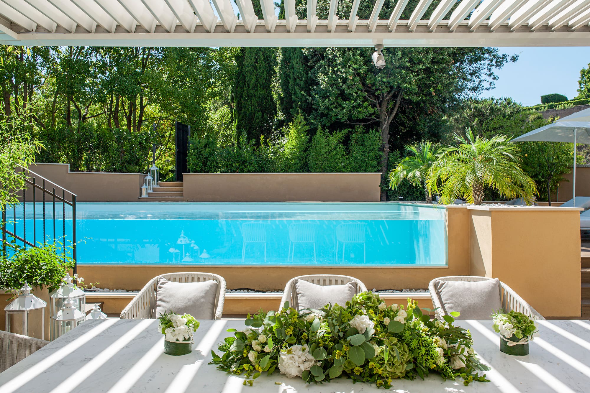 a table with chairs and flowers on it