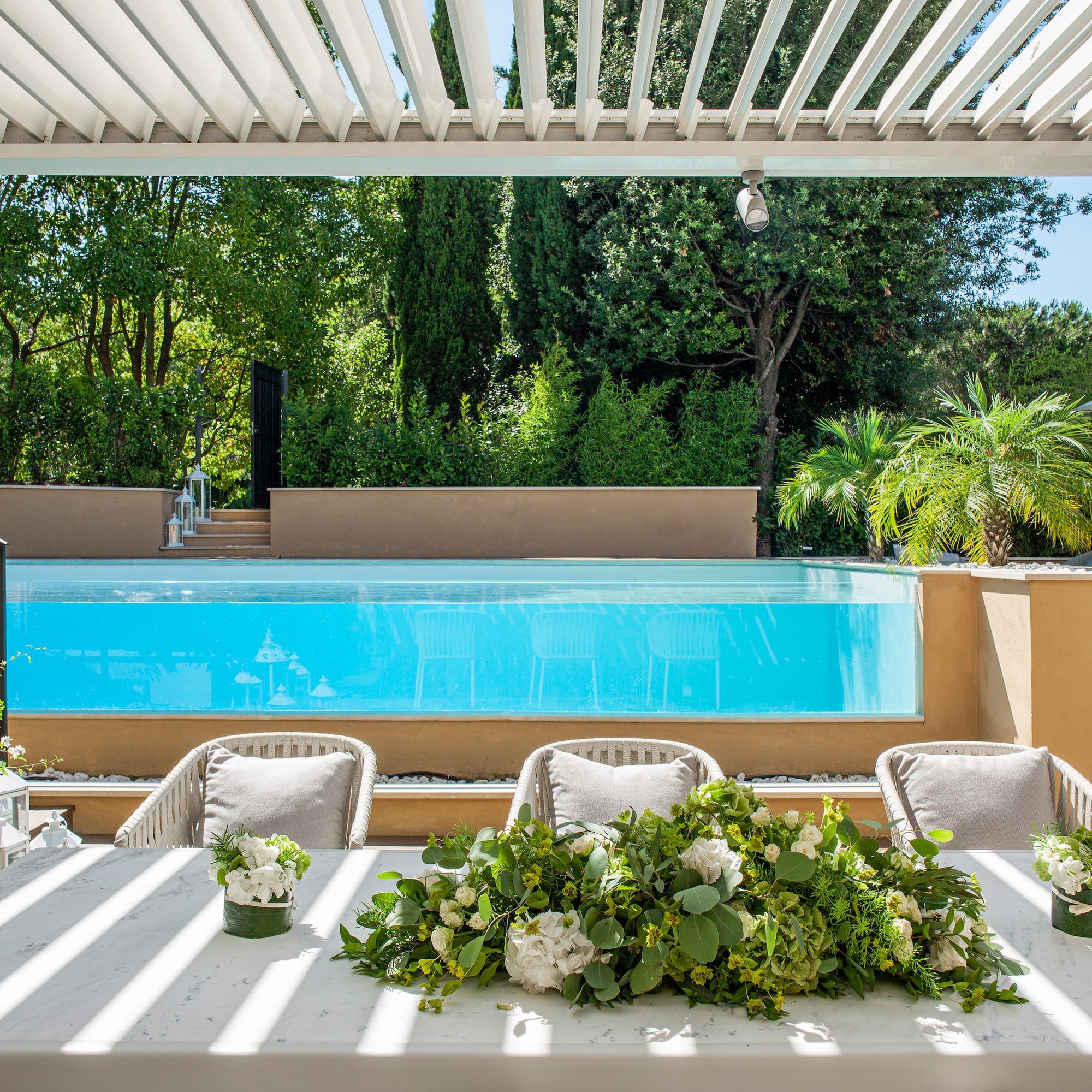 a table with chairs and flowers on it