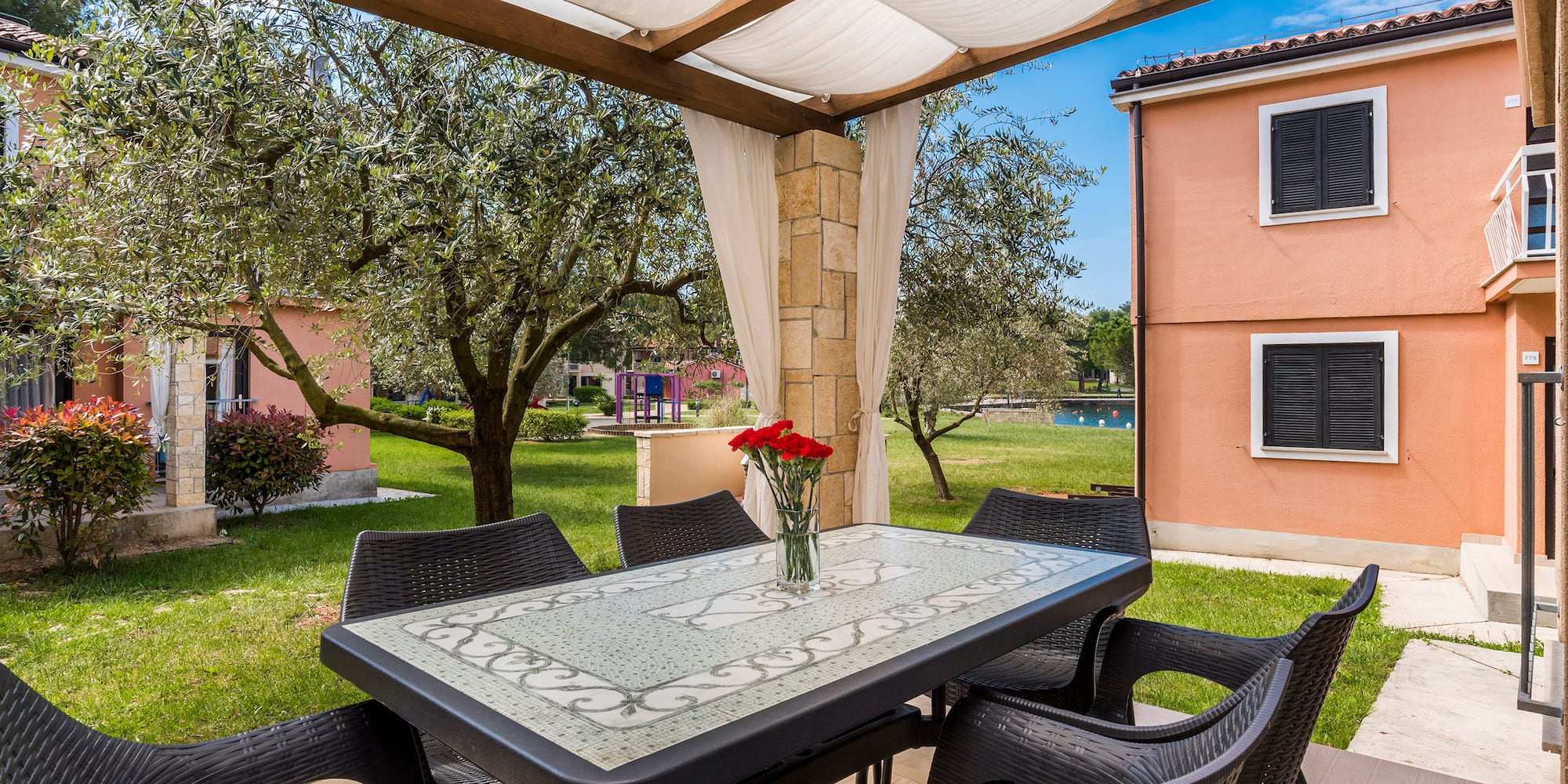 a table and chairs under a canopy