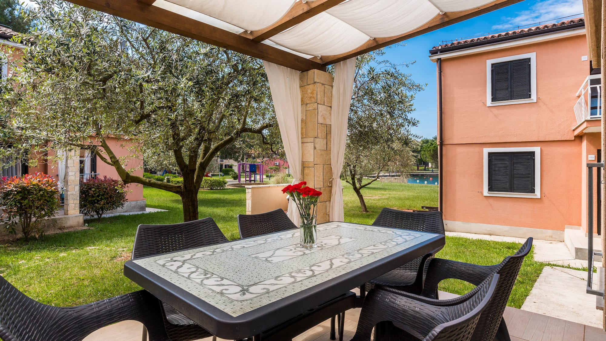 a table and chairs under a canopy