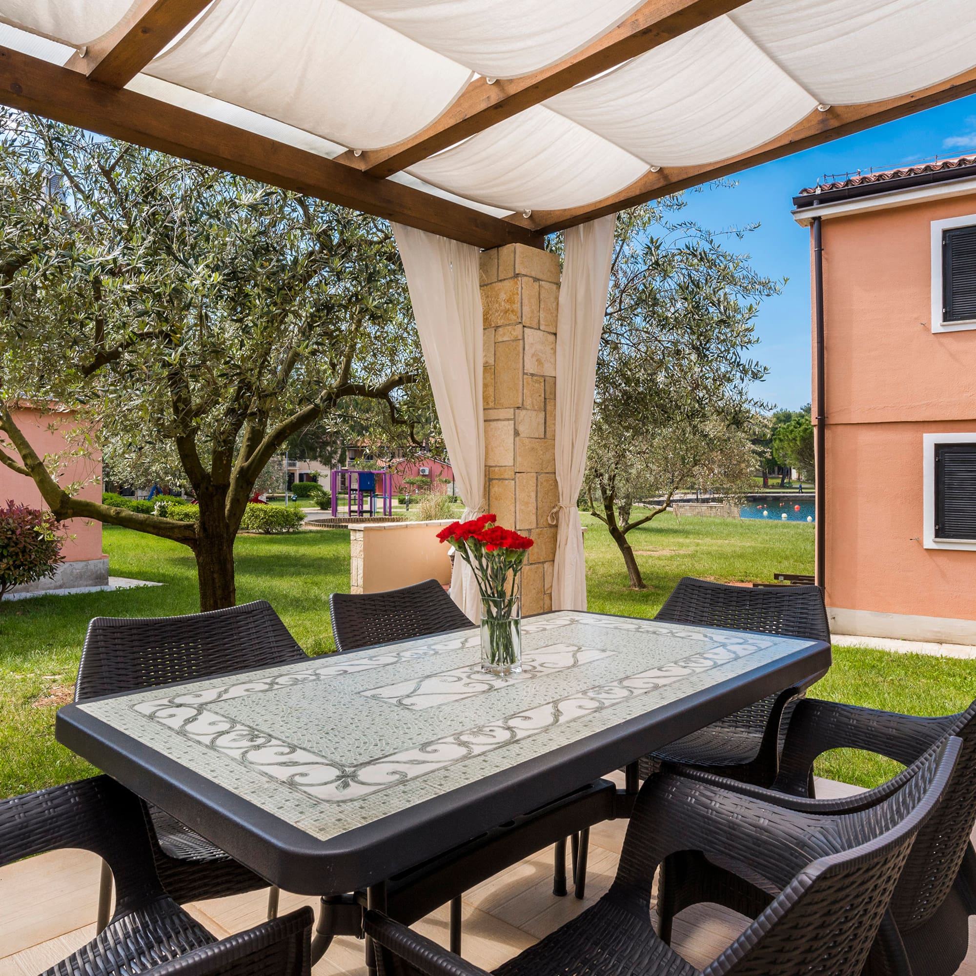 a table and chairs under a canopy