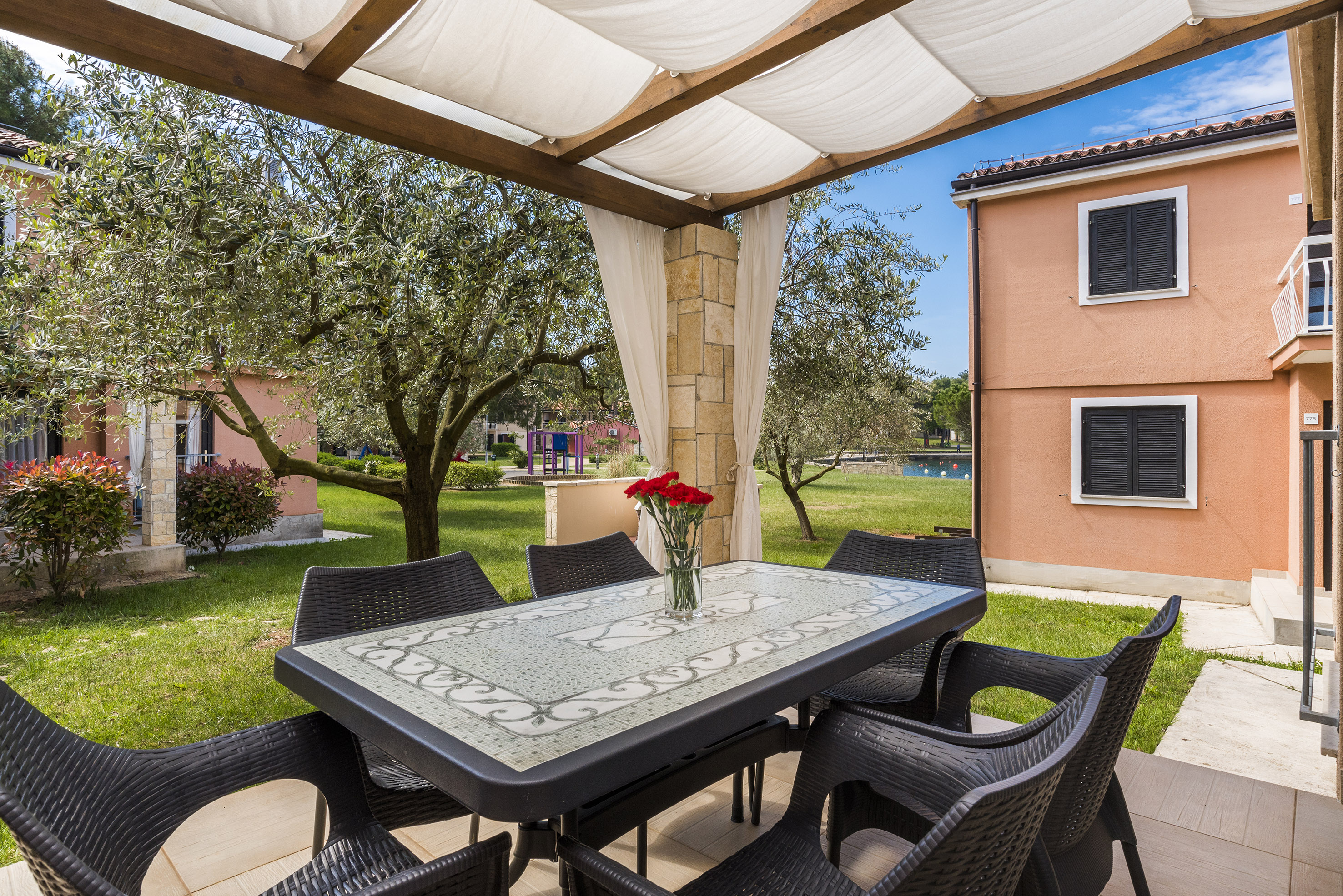 a table and chairs under a canopy