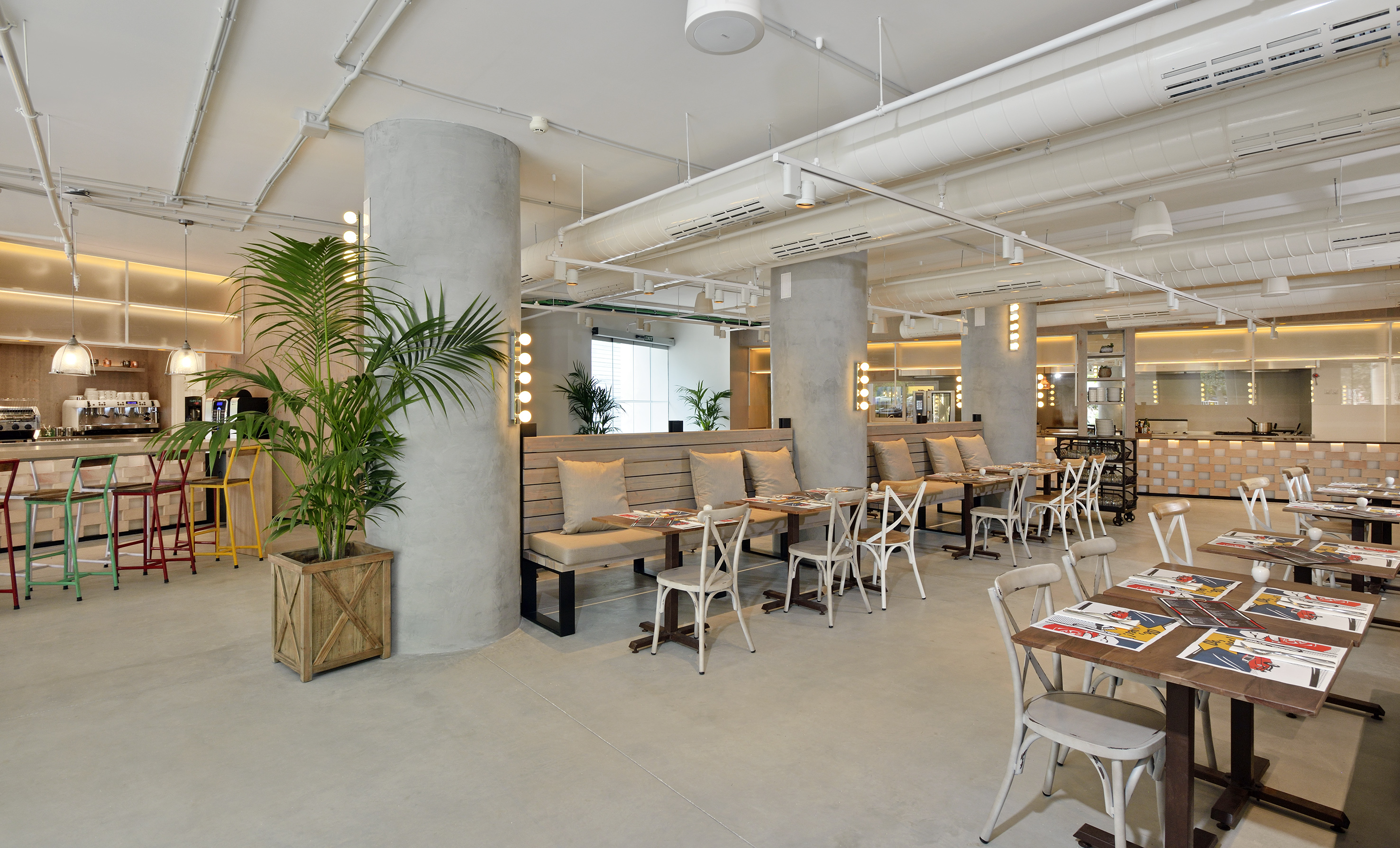 Modern restaurant interior, concrete pillars, industrial design, dining booths, bar.