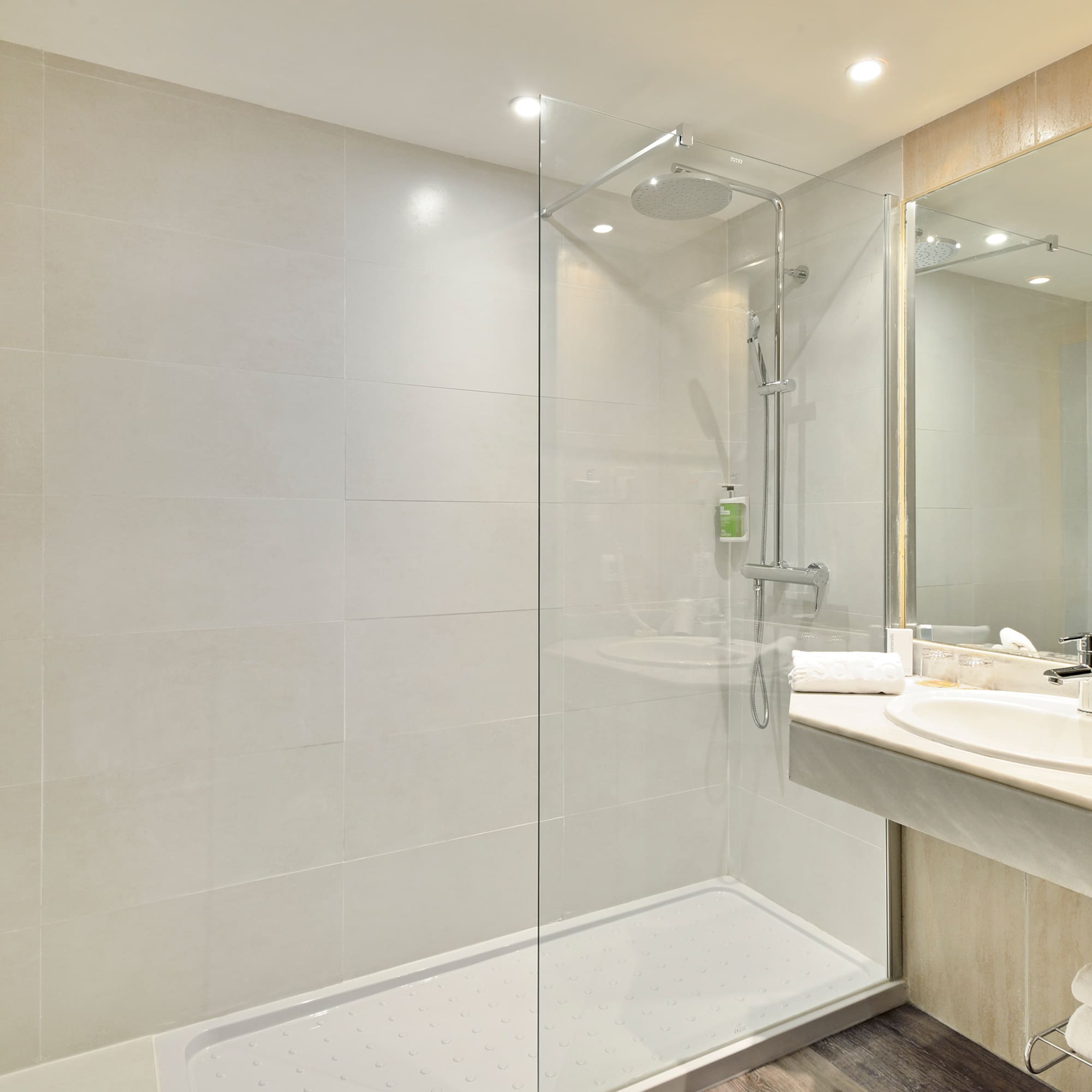 a bathroom with a glass shower and sink