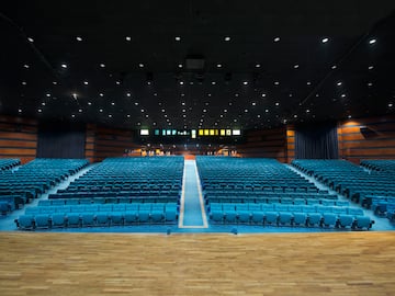 a large auditorium with blue seats