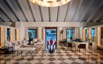 a room with a checkered floor and a table and chairs