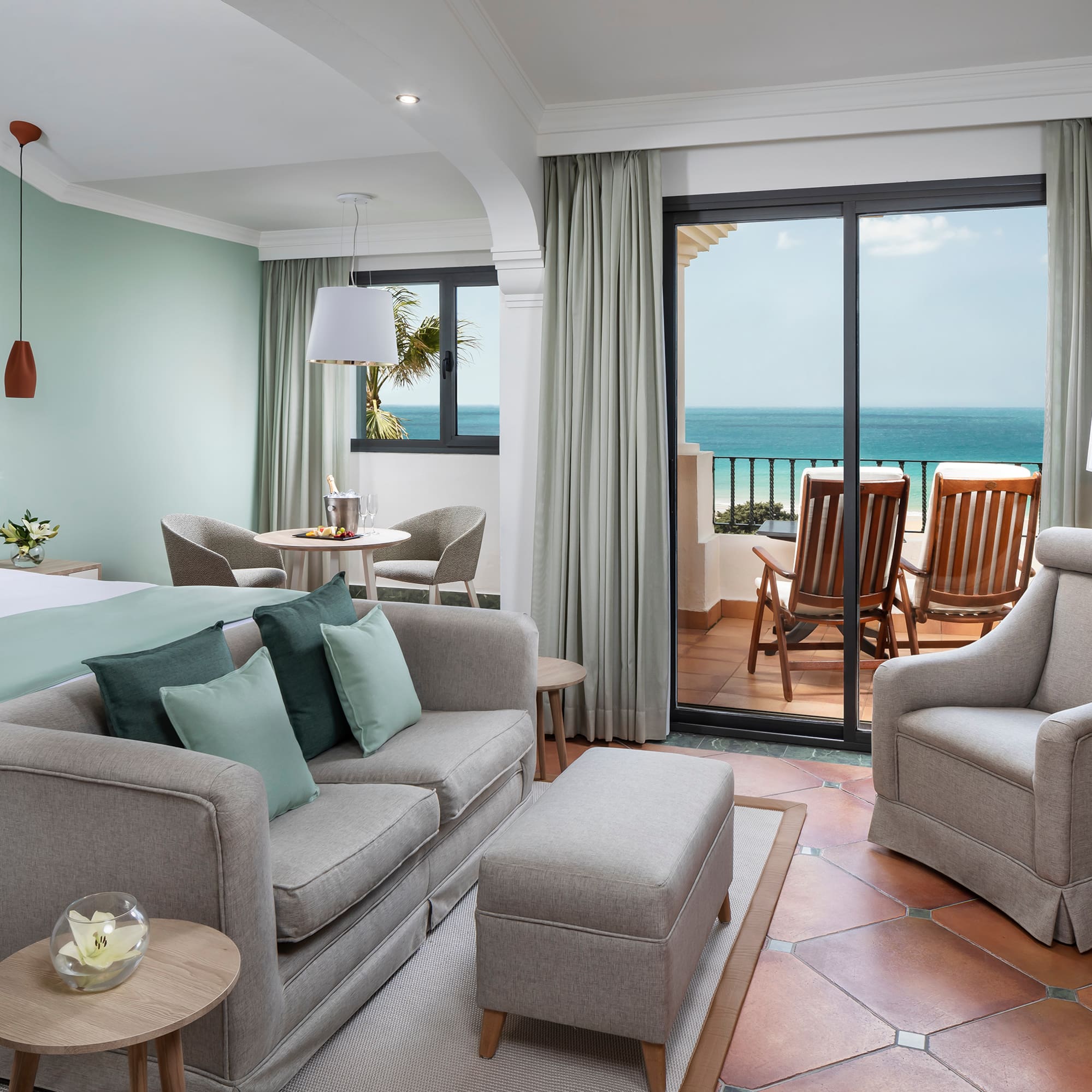 a room with a bed and chairs and a table