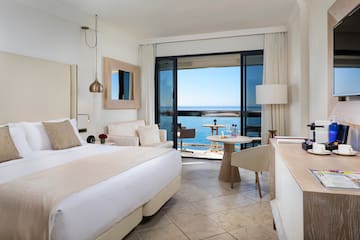 a room with a bed and a table and chairs