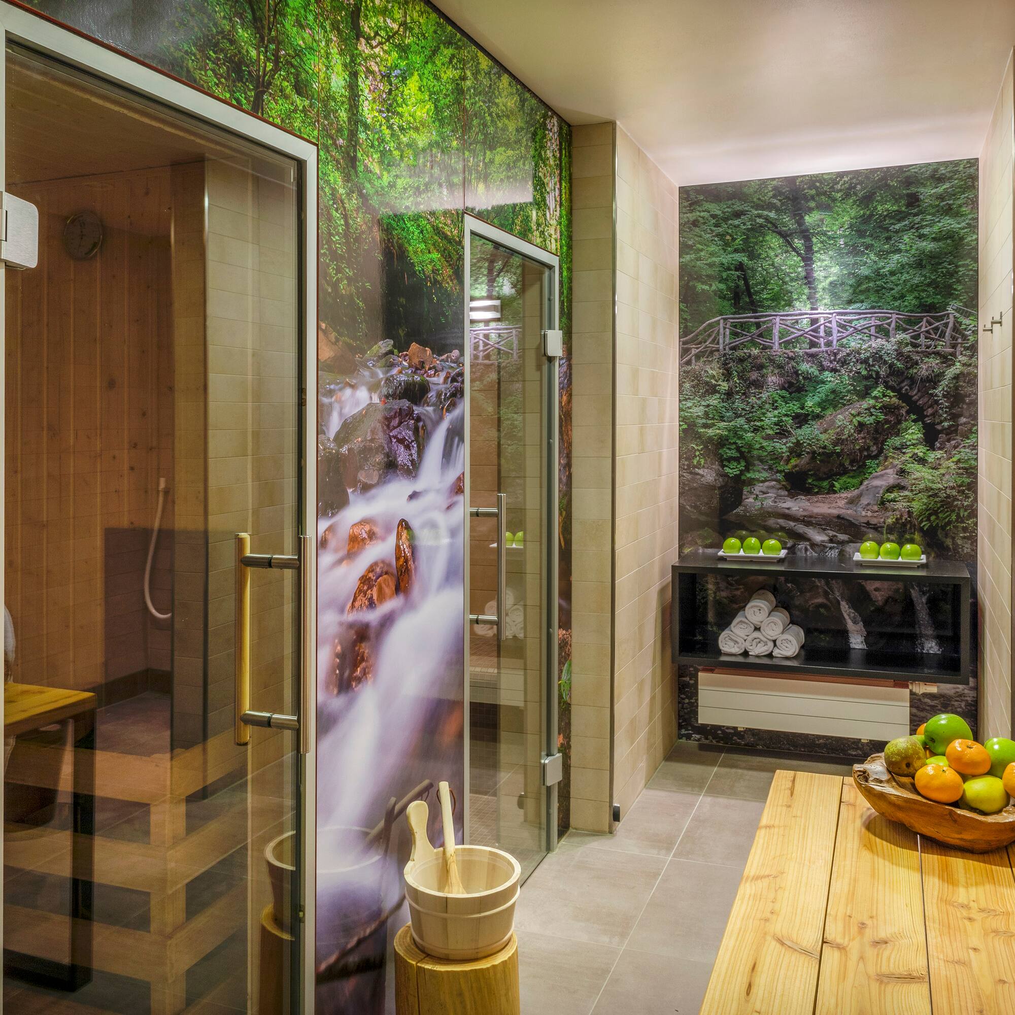 a room with a glass shower and a wooden bench