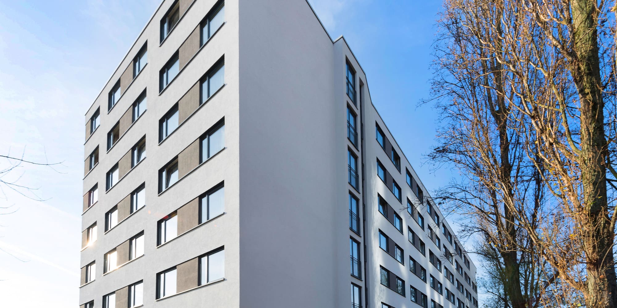 a building with trees and a road