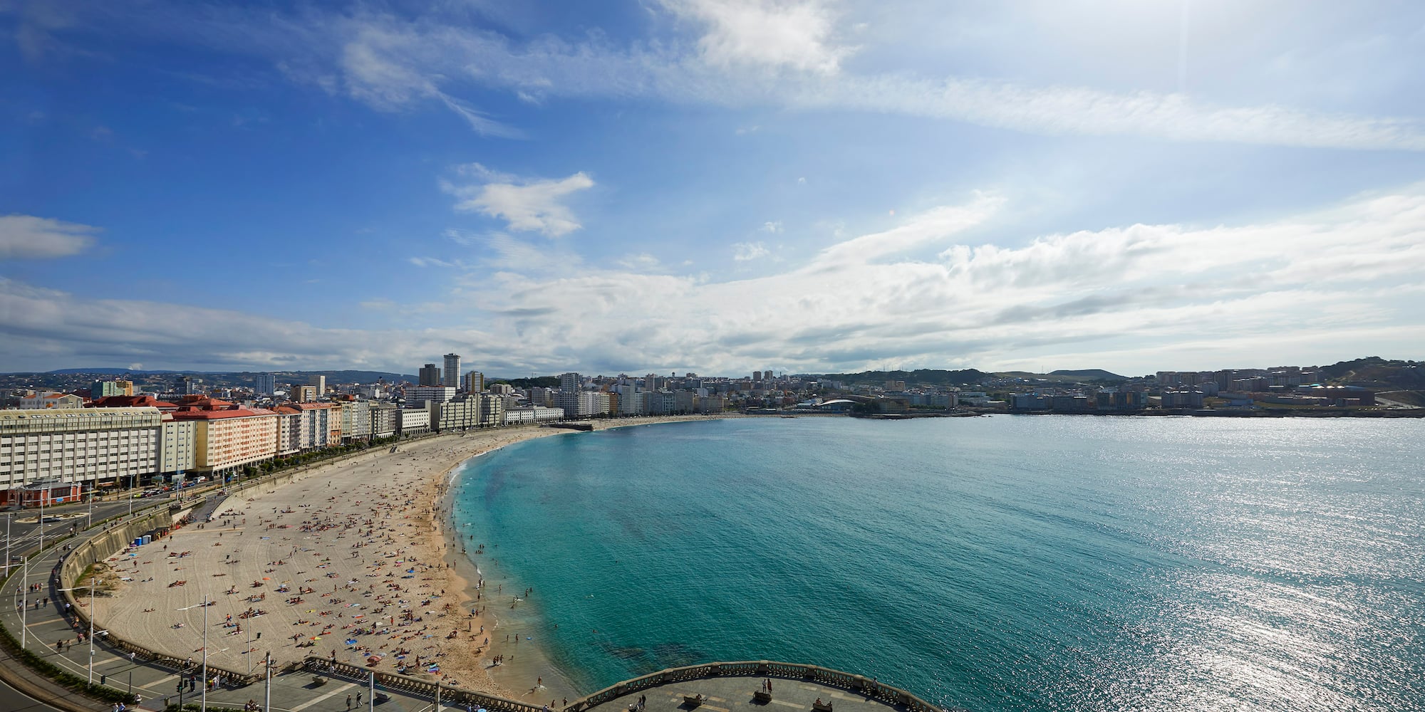 a beach with buildings and water