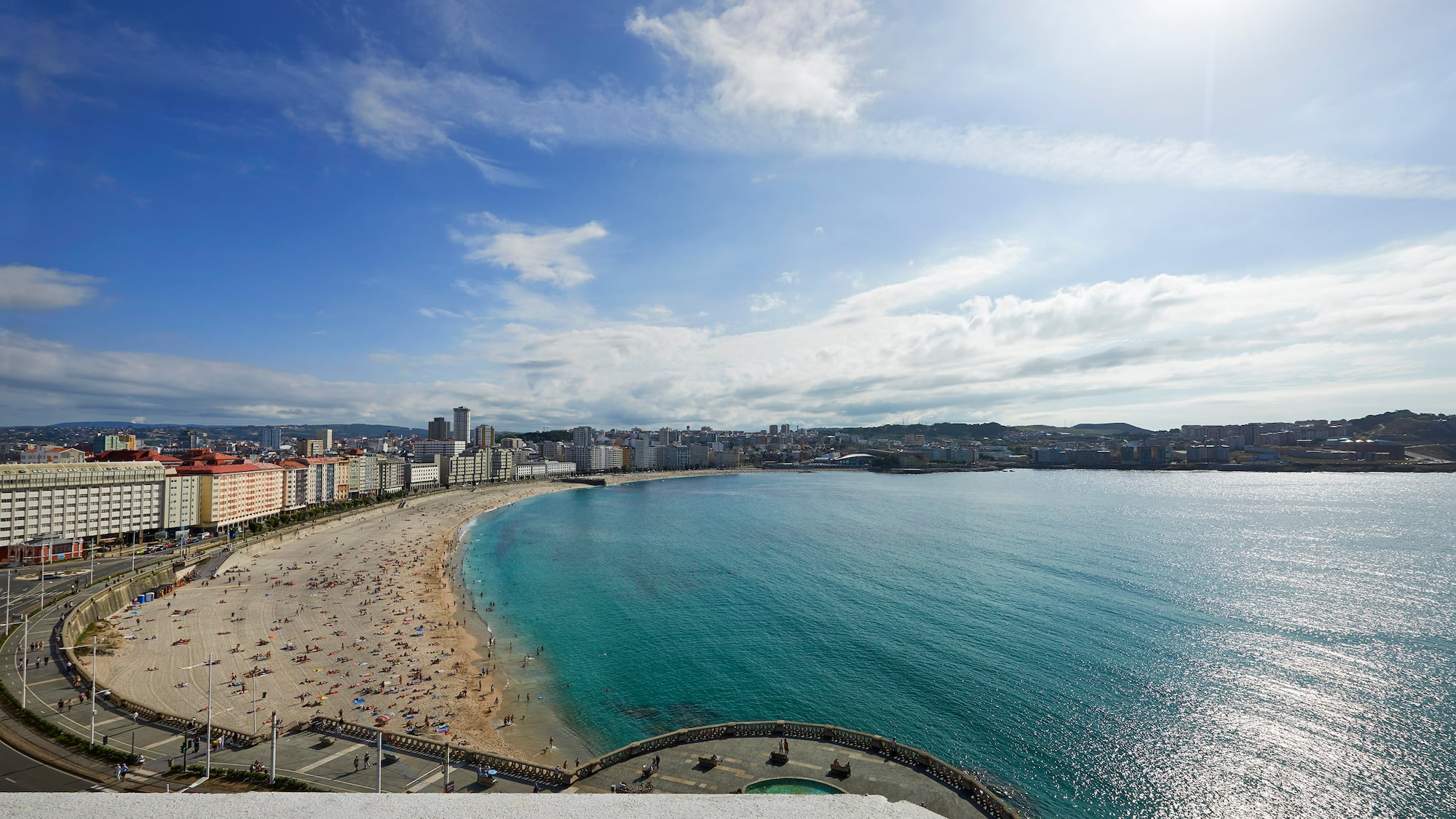 a beach with buildings and water